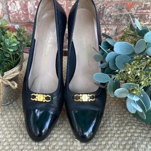 Salvatore Ferragamo black size 8 black and gold accents.